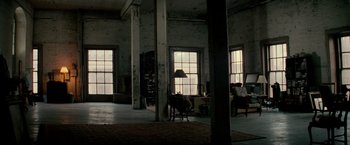 Movie still from “Michael Clayton” (2007), directed by Tony Gilroy – A living room with two large windows and a chair in it; Extreme Wide shot, Low angle