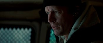 Movie still from “Michael Clayton” (2007), directed by Tony Gilroy – A person wearing a hat looking to his left; Close Up shot, Low angle