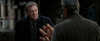 Movie still from “Michael Clayton” (2007), directed by Tony Gilroy – A man in a black jacket and a man in a black jacket; Medium shot, Over the shoulder angle