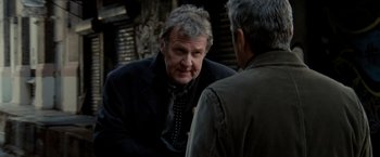 Movie still from “Michael Clayton” (2007), directed by Tony Gilroy – A man wearing a suit and tie talking to another man wearing a jacket; Close Up shot, Over the shoulder angle