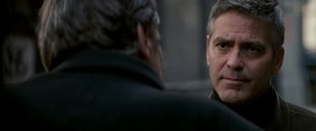 Movie still from “Michael Clayton” (2007), directed by Tony Gilroy – Two men talking to each other in front of a building; Close Up shot, Over the shoulder angle