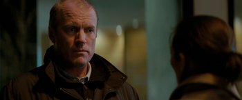 Movie still from “Michael Clayton” (2007), directed by Tony Gilroy – A person wearing a jacket; Close Up shot, Over the shoulder angle