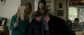 Movie still from “Michael Clayton” (2007), directed by Tony Gilroy – A woman and two men are combing a young boy's hair; Medium shot, Over the shoulder angle