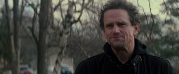 Movie still from “Michael Clayton” (2007), directed by Tony Gilroy – A person with curly hair wearing a jacket; Close Up shot, Over the shoulder angle