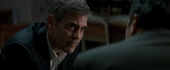 Movie still from “Michael Clayton” (2007), directed by Tony Gilroy – A person wearing a suit and tie; Close Up shot, Over the shoulder angle