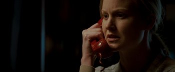 Movie still from “Michael Clayton” (2007), directed by Tony Gilroy – A woman holding a red phone up to her ear; Close Up shot, Low angle