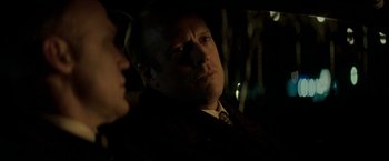 Movie still from “Michael Clayton” (2007), directed by Tony Gilroy – A man in a suit and tie next to a woman; Close Up shot, Over the shoulder angle