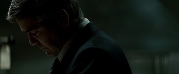 Movie still from “Michael Clayton” (2007), directed by Tony Gilroy – A person wearing a suit and tie; Close Up shot, Over the shoulder angle