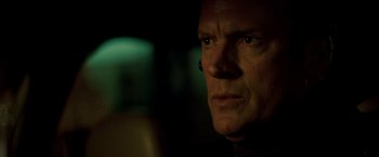 Movie still from “Michael Clayton” (2007), directed by Tony Gilroy – A man's face in the dark; Close Up shot, Over the shoulder angle