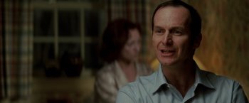 Movie still from “Michael Clayton” (2007), directed by Tony Gilroy – A person wearing a shirt and a tie; Close Up shot, Over the shoulder angle