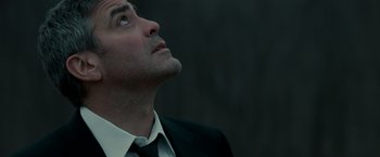 Movie still from “Michael Clayton” (2007), directed by Tony Gilroy – A person wearing a suit and tie; Close Up shot, Low angle