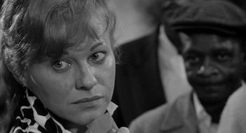 Movie still from “Mickey One” (1965), directed by Arthur Penn – Black and white photograph of a woman looking into the camera; Close Up shot, Over the shoulder angle