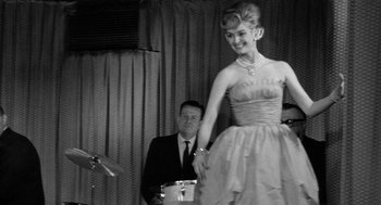 Movie still from “Mickey One” (1965), directed by Arthur Penn – A man and a woman in a black and white photo; Medium shot, Low angle