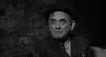 Movie still from “Mickey One” (1965), directed by Arthur Penn – An older man wearing a hat and a suit; Close Up shot, High angle