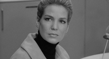 Movie still from “Mickey One” (1965), directed by Arthur Penn – Black and white photograph of a woman in a black jacket; Close Up shot, Low angle