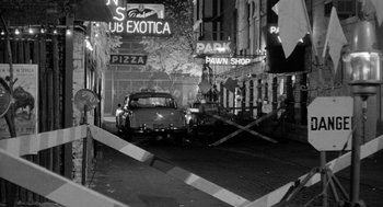 Movie still from “Mickey One” (1965), directed by Arthur Penn – A car parked on the side of the street; Wide shot, High angle
