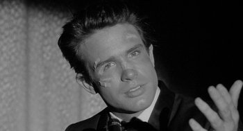 Movie still from “Mickey One” (1965), directed by Arthur Penn – A black and white photo of a man with bandages on his face; Close Up shot, Low angle