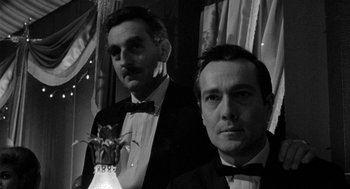 Movie still from “Mickey One” (1965), directed by Arthur Penn – A black and white photo of two men in tuxedos; Close Up shot, Low angle