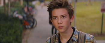 Movie still from “Middle School: The Worst Years of My Life” (2016), directed by Steve Carr – A young man with brown hair wearing a yellow and blue plaid shirt; Close Up shot, Over the shoulder angle