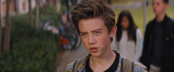 Movie still from “Middle School: The Worst Years of My Life” (2016), directed by Steve Carr – A young man with brown hair wearing a checkered shirt; Close Up shot, Over the shoulder angle