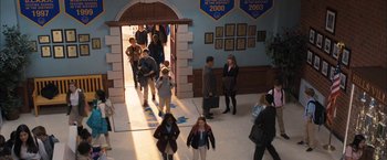 Movie still from “Middle School: The Worst Years of My Life” (2016), directed by Steve Carr – A group of people walking through a hallway; Wide shot, High angle