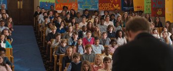 Movie still from “Middle School: The Worst Years of My Life” (2016), directed by Steve Carr – A large group of children sitting in front of a classroom; Wide shot, High angle