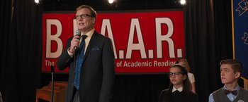 Movie still from “Middle School: The Worst Years of My Life” (2016), directed by Steve Carr – A man and a woman standing next to each other on a stage; Medium shot, Over the shoulder angle