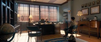 Two people sitting at a desk in a room
