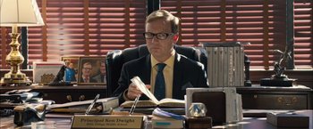 Movie still from “Middle School: The Worst Years of My Life” (2016), directed by Steve Carr – A man sitting at a desk reading a book; Medium shot, Over the shoulder angle