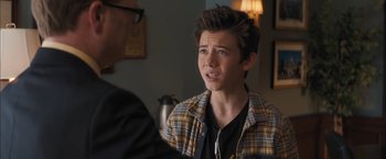 Movie still from “Middle School: The Worst Years of My Life” (2016), directed by Steve Carr – A young man in a plaid shirt talking to an older man; Close Up shot, Over the shoulder angle