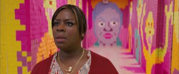 Movie still from “Middle School: The Worst Years of My Life” (2016), directed by Steve Carr – A woman standing in front of a painting of a face; Close Up shot, Over the shoulder angle