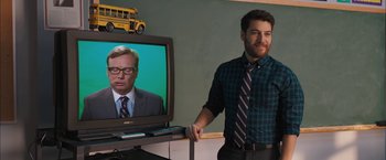 Movie still from “Middle School: The Worst Years of My Life” (2016), directed by Steve Carr – A man standing in front of a television; Medium shot, Over the shoulder angle