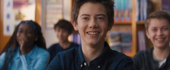 Movie still from “Middle School: The Worst Years of My Life” (2016), directed by Steve Carr – A young man smiling for the camera while another looks on; Close Up shot, Over the shoulder angle