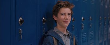Movie still from “Middle School: The Worst Years of My Life” (2016), directed by Steve Carr – A young man standing in front of two blue lockers; Close Up shot, Over the shoulder angle