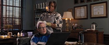 Movie still from “Middle School: The Worst Years of My Life” (2016), directed by Steve Carr – A man getting his head shaved by a woman; Medium shot, Over the shoulder angle