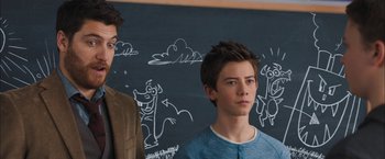 Movie still from “Middle School: The Worst Years of My Life” (2016), directed by Steve Carr – Two young men standing next to each other in front of a chalkboard; Close Up shot, Over the shoulder angle