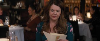 Movie still from “Middle School: The Worst Years of My Life” (2016), directed by Steve Carr – A woman is holding an envelope and looking down at it; Close Up shot, Over the shoulder angle