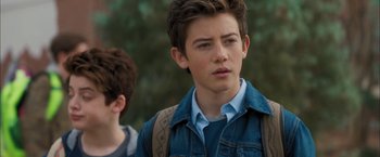 Movie still from “Middle School: The Worst Years of My Life” (2016), directed by Steve Carr – A young man with a backpack and a blue shirt; Close Up shot, Over the shoulder angle