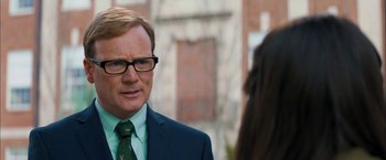 Movie still from “Middle School: The Worst Years of My Life” (2016), directed by Steve Carr – A man in a suit and tie standing next to a woman; Close Up shot, Over the shoulder angle