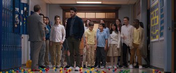 Movie still from “Middle School: The Worst Years of My Life” (2016), directed by Steve Carr – A group of people standing in front of balloons; Wide shot, Over the shoulder angle