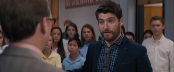 Movie still from “Middle School: The Worst Years of My Life” (2016), directed by Steve Carr – A group of young people standing in a room with a man in front of them; Close Up shot, Over the shoulder angle