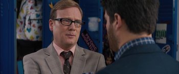Movie still from “Middle School: The Worst Years of My Life” (2016), directed by Steve Carr – A man in a suit and tie talking to another man; Close Up shot, Over the shoulder angle