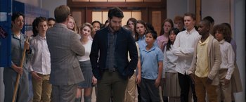 Movie still from “Middle School: The Worst Years of My Life” (2016), directed by Steve Carr – A group of people standing in a room; Medium shot, Over the shoulder angle