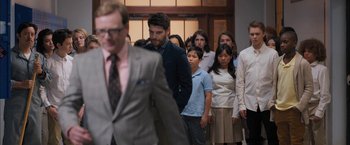 Movie still from “Middle School: The Worst Years of My Life” (2016), directed by Steve Carr – A group of people standing in a room; Medium shot, Over the shoulder angle