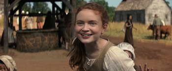 Movie still from “Fear Street: Part Three - 1666” (2021), directed by Leigh Janiak – A young woman with red hair smiling for the camera; Close Up shot, Over the shoulder angle