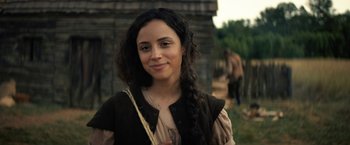 Movie still from “Fear Street: Part Three - 1666” (2021), directed by Leigh Janiak – A young woman with long black curly hair; Close Up shot, Over the shoulder angle