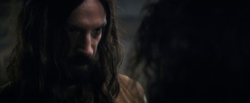 Movie still from “Fear Street: Part Three - 1666” (2021), directed by Leigh Janiak – A man with long hair and a long beard; Close Up shot, Over the shoulder angle