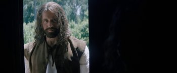 Movie still from “Fear Street: Part Three - 1666” (2021), directed by Leigh Janiak – A man with long hair is standing outside; Close Up shot, Over the shoulder angle