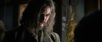 Movie still from “Fear Street: Part Three - 1666” (2021), directed by Leigh Janiak – A man with long hair and a long beard; Close Up shot, Low angle