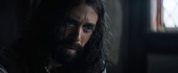 Movie still from “Fear Street: Part Three - 1666” (2021), directed by Leigh Janiak – A person with long hair and a beard; Close Up shot, Over the shoulder angle
